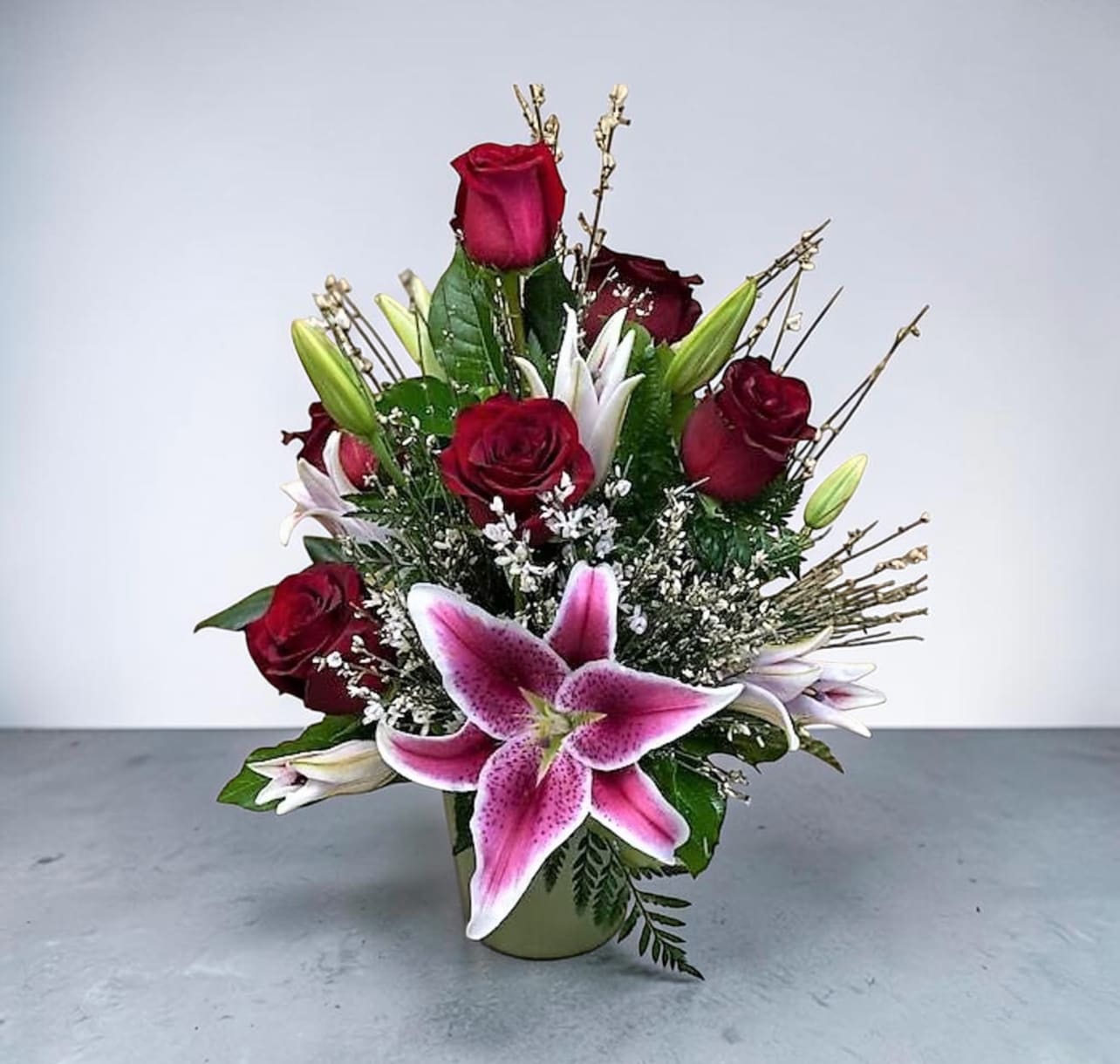 Gazing Roses - What a statement these 1/2 dozen Red Roses make with the addition of Star Gazier Lilies and filler. 