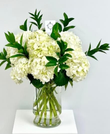 White hydrangea bouquet in a clear glass vase