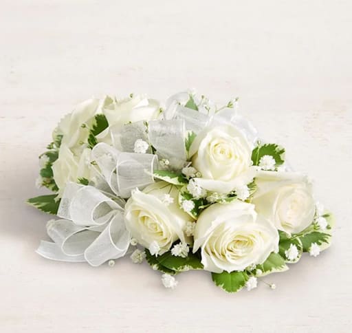White rose bouquet with baby's breath and a sheer ribbon