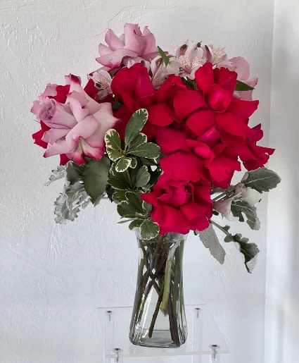 Bouquet of red and pink roses in a clear glass vase