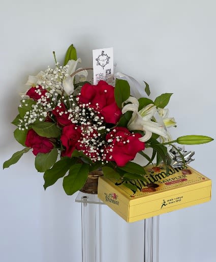 Bouquet of red roses and white lilies with a yellow gift box