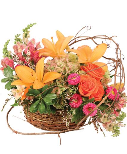 Basket arrangement with orange lilies and pink flowers