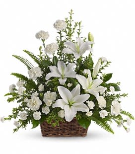 White lilies and carnations in a wicker basket
