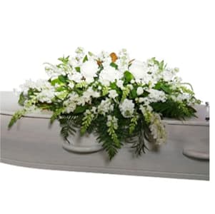 Tranquil Skies - A full casket spray of crisp white blooms &amp; lush greenery for a classic, distinguished look. This arrangement brings a sense of peace &amp; solemn beauty to the service.