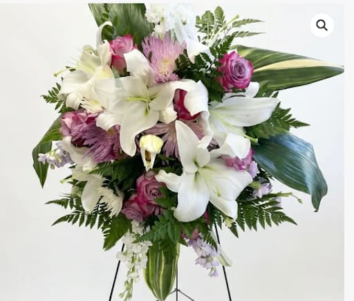 Lavender Reflections Spray - Romantic standing spray featuring white lilies, lavender roses &amp; white chrysanthemums. A graceful &amp; expressive arrangement for meaningful occasions.