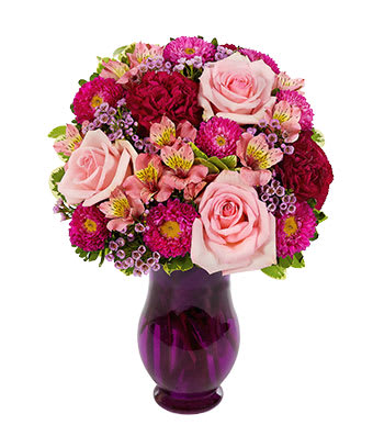 All My Love - The love the two of you share is special, and so is this beautiful arrangement. Light pink roses, magenta carnations, pink alstroemeria, purple waxflower and pink Matsumoto aster combine in a lovely glass vase to express the essence of romantic thoughts. Small Measures 12"H X 8"L. Medium Measures 13"H X 9"L. Large Measures 14"H X 10"L.