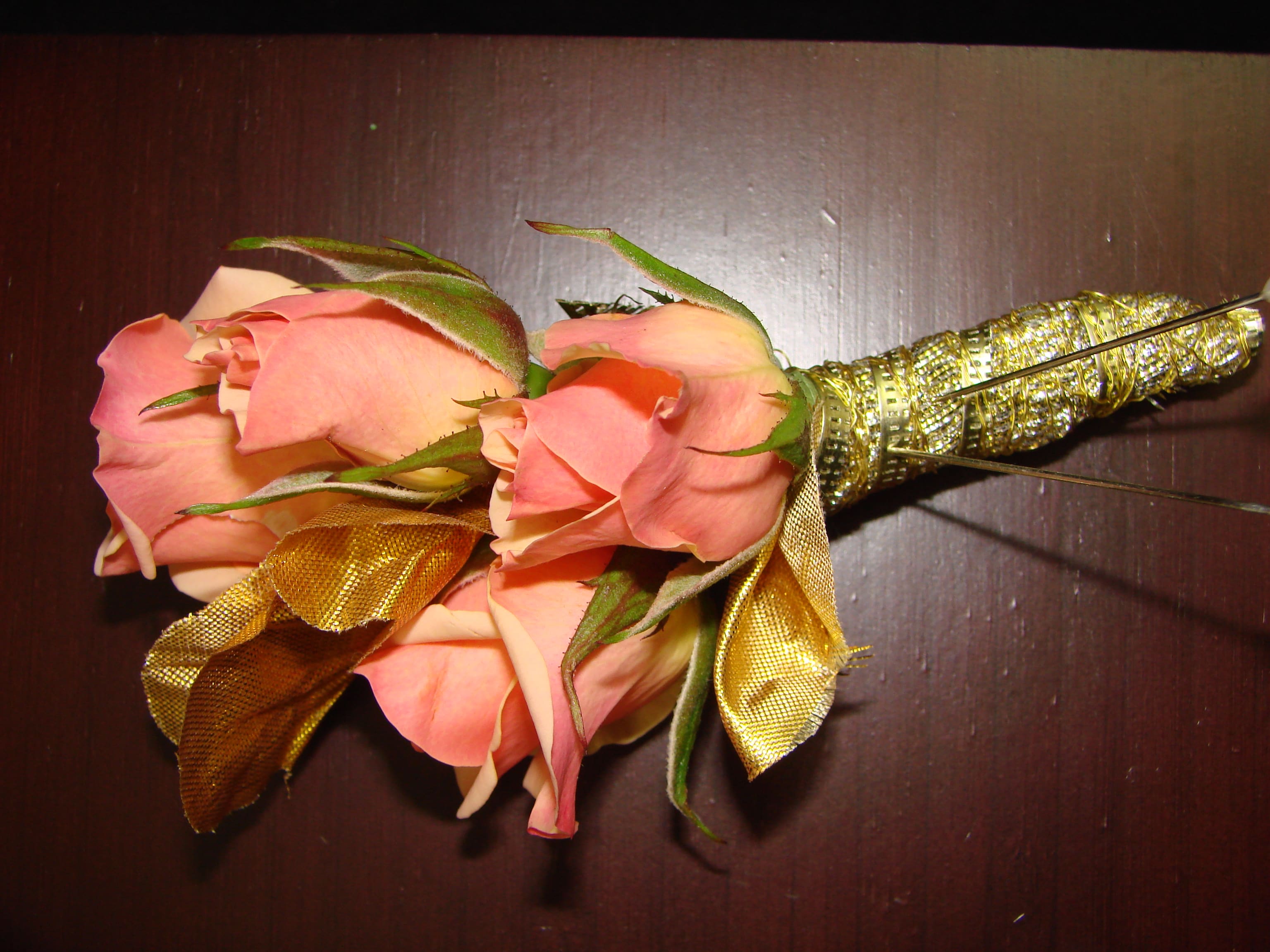 Pink rose boutonniere with gold ribbon wrap
