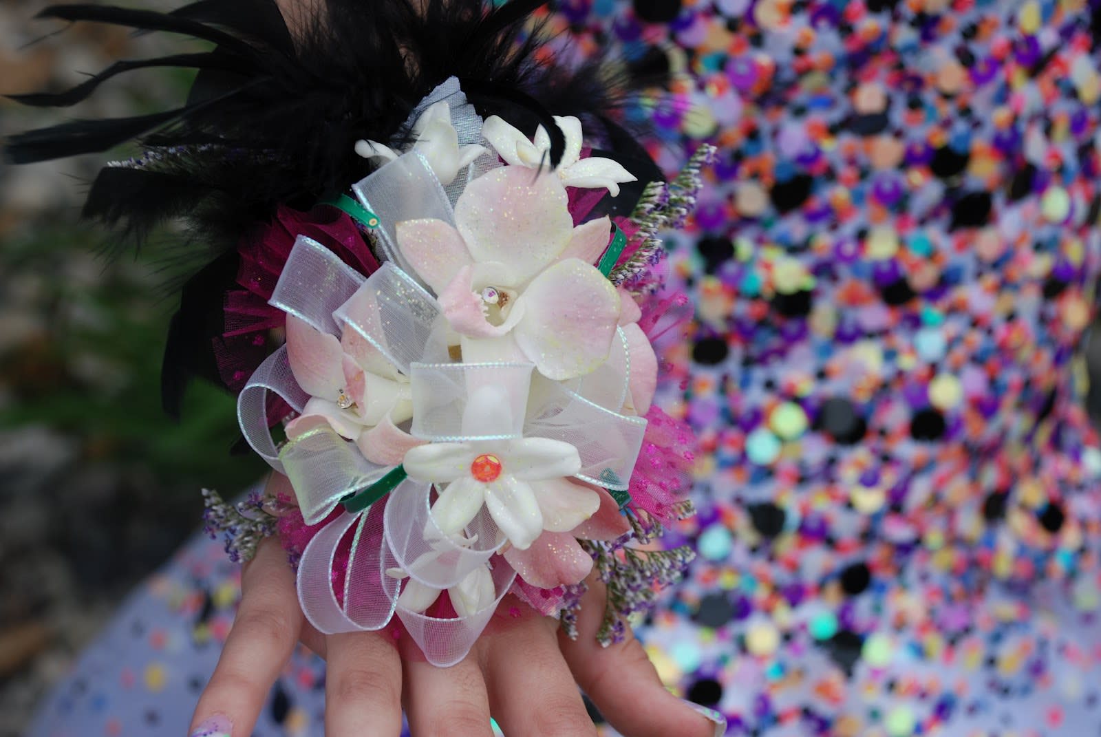 Handheld corsage with white and pale pink flowers and ribbon