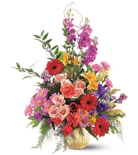 Colorful mixed flower arrangement in a gold vase