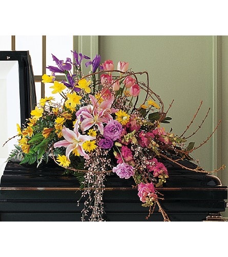 Colorful floral spray on a black casket