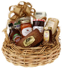 Gift basket with jams, honey, and packaged treats in a wicker basket