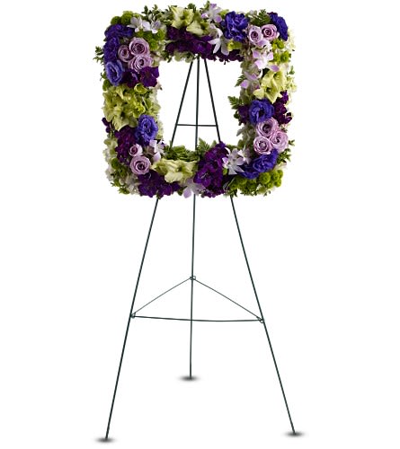 Purple and green floral wreath on a black easel