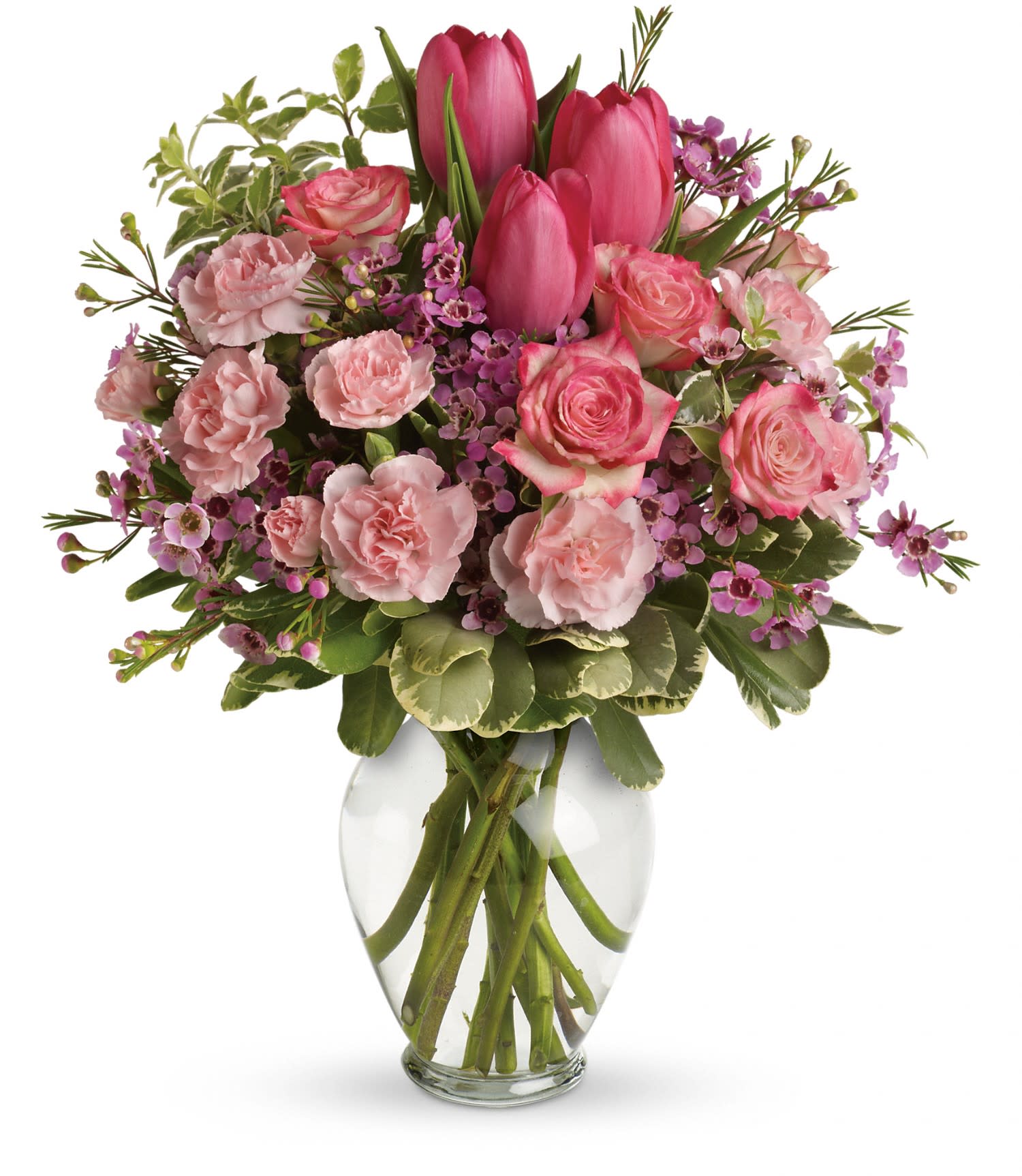 Pink tulips, roses, and carnations arranged in a clear glass vase