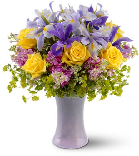 Yellow roses and purple iris in a lavender vase