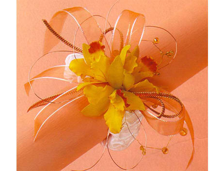 Yellow orchid corsage with orange ribbon and decorative wire loops