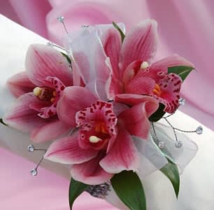 Pink orchid bouquet with white ribbon and decorative beads