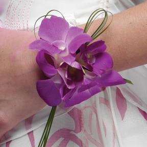 Purple orchid wrist corsage with looped wire accents