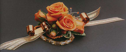 Orange rose corsage with ribbon and beaded accents