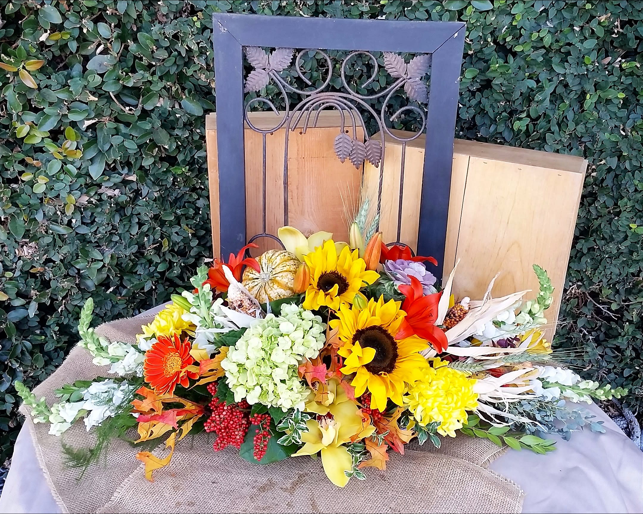 Grand table Centerpiece - Orchids, Lilies, Hydrangea, Snapdragon, Kale, Pumpkins,Gourds and seasonal premium flowers designed to make any table lush and bountiful! This beautiful centerpiece is sure to get you in the spirit.