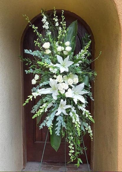 Tall white floral standing spray on an easel