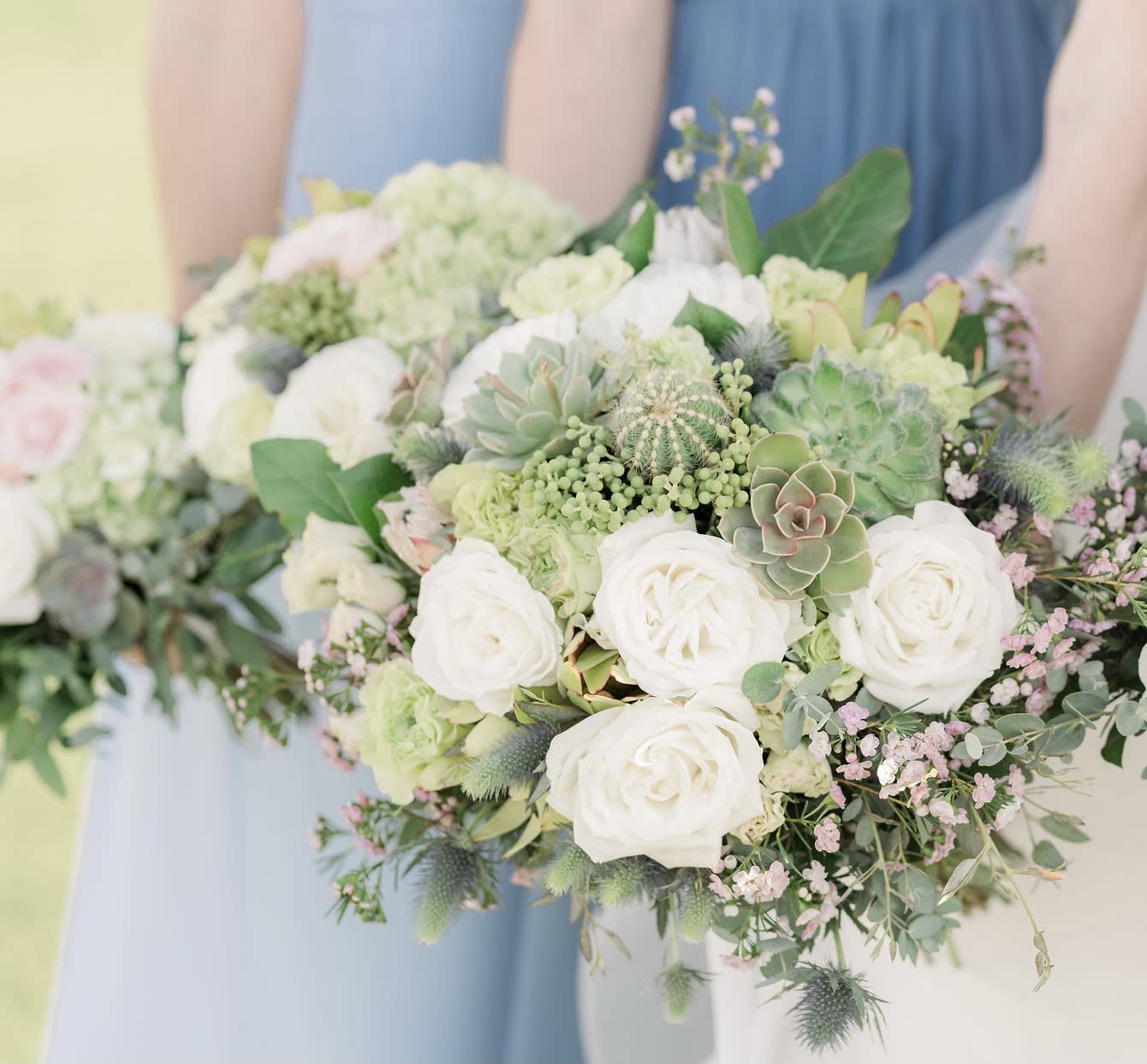 White rose and succulent bouquet with soft pink accents