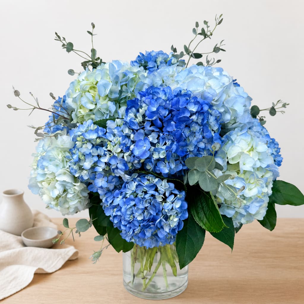 Blue hydrangea bouquet in a clear glass vase