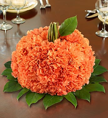 Fresh Flower Pumpkin - Product ID: 103582  EXCLUSIVE This fresh pumpkin-shaped arrangement is our best pick for sending smiles. Filled with bright orange carnations, it makes a truly original centerpiece for Halloween parties, housewarmings or Fall birthdays. Artistically crafted by our floral designers, they'll swear it came straight from the pumpkin patch! Hand-crafted pumpkin-shaped flower arrangement of orange carnations and salal Arrangement measures approximately 6.5"H x 7"L Our florists select the freshest flowers available, so colors, varieties and container may vary due to local availability