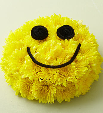 Smile Bouquet - Product ID: 90235   If you're anything like us, you love delivering smiles. And here's just the gift to do it! Vibrant yellow blooms are hand-designed by our expert florists in the shape of a cake and decorated like a great big smiley face. Itâs a truly original way to celebrate a birthday, say thanks or just get them grinning. Vibrant yellow cushion poms designed in floral foam and tray to resemble a birthday cake Features an iconic smiley face Arrangement measures approximately 4"H x 9"D Our florists hand-design each arrangement, so colors and varieties may vary due to local availability