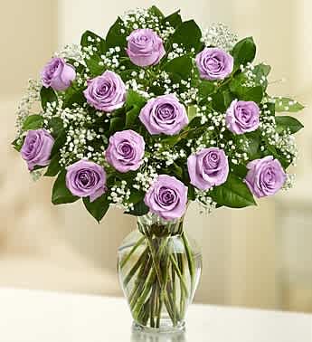 Rose Elegance Premium Long Stem Purple Roses - Product ID: 105257  Your special someone deserves to be treated like royalty. Put the crowning touch on their day with our hand-designed arrangement of 12 or 18 gorgeous long-stem purple roses, gathered in a classic vase. Our florists select only the finest, freshest long-stem purple roses and arrange them by hand with fresh gypsophila in a classic glass vase Available in bouquets of 12 stems and 18 stems 18-stem arrangement measures approximately 22"H x 18"L 12-stem arrangement measures approximately 22"H x 15"L Vase measures 11"H Our florists hand-design each arrangement, so colors, varieties, and container may vary due to local availability