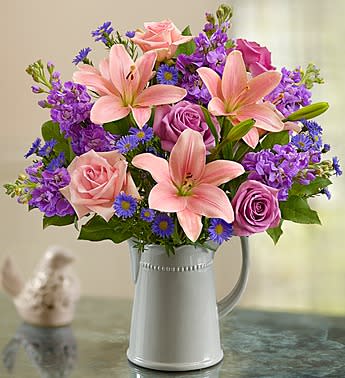 Make Her Day Bouquet - Product ID: 140459  EXCLUSIVE It's her day. Make it one she'll always remember with our gorgeous, garden-inspired arrangement of light pink &amp; lavender roses, pink Asiatic lilies and more, artistically hand-designed by our florists in a grey ceramic pitcher she can use again and again. Fresh bouquet of light pink and lavender roses, pink Asiatic lilies, lavender stock, monte casino and salal Arranged by our expert florists in a striking, food-safe grey handled ceramic pitcher; measures 6.75H x 3.75"D Large arrangement measures approximately 19"H x 16"L Medium arrangement measures approximately 18"H x 15"L Small arrangement measures approximately 19"H x 16"L Our florists select the freshest flowers available, so colors and varieties may vary due to local availability