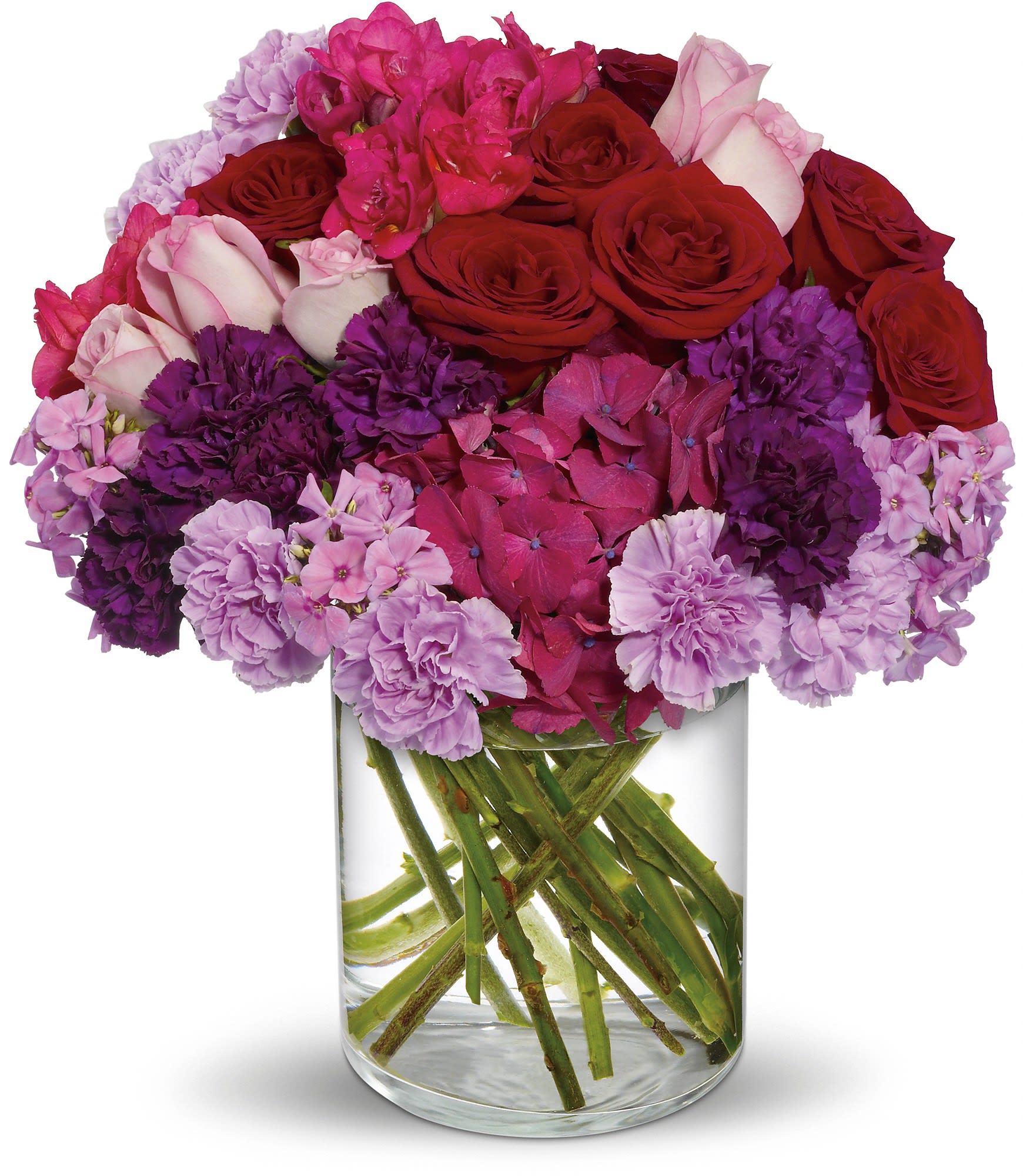 Bouquet of red roses and pink-purple flowers in a clear glass vase