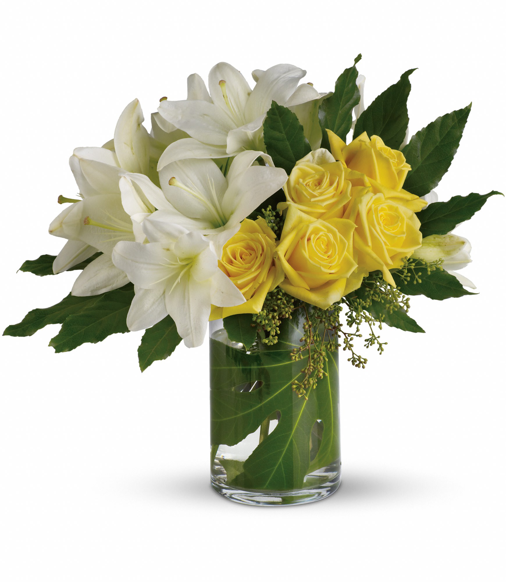 White lilies and yellow roses in a glass vase