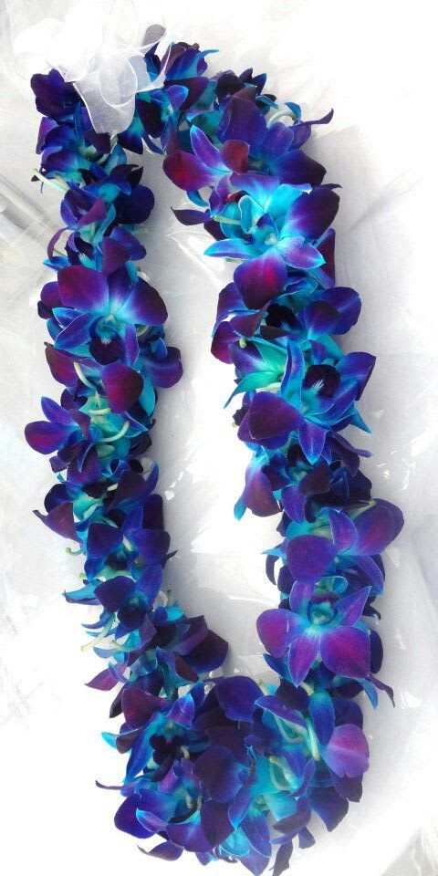 Purple and blue flower lei on white fabric