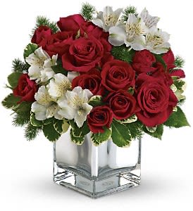 Teleflora’s Christmas Blush Bouquet    - The stylish Christmas flower arrangement includes red roses, red spray roses and white alstroemeria accented with pittosporum and ming fern. Approximately 11 1/2" W x 12" H 