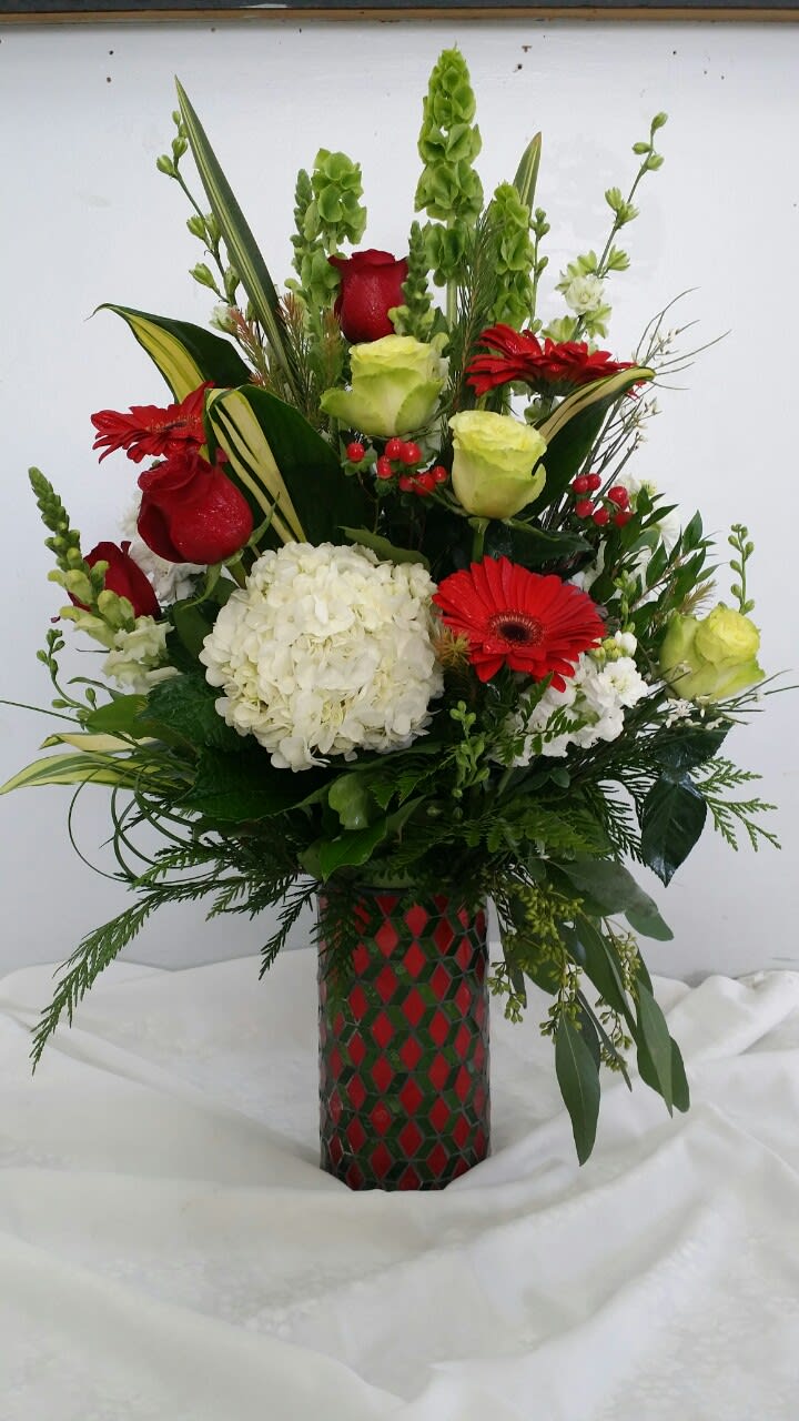 Red and white floral arrangement in a patterned vase