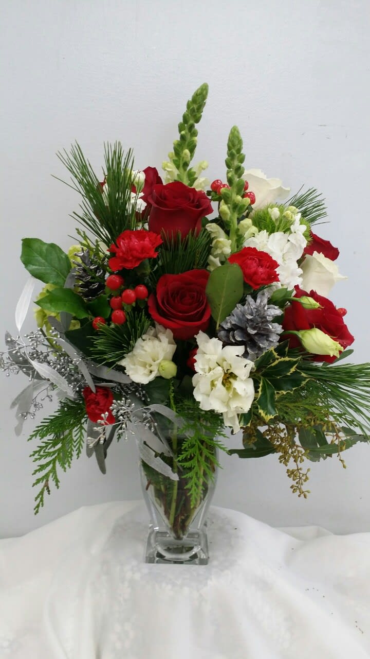 Red and white flower arrangement in a clear glass vase