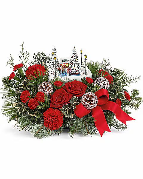 Christmas floral centerpiece with red roses and carnations, pine, and a red ribbon