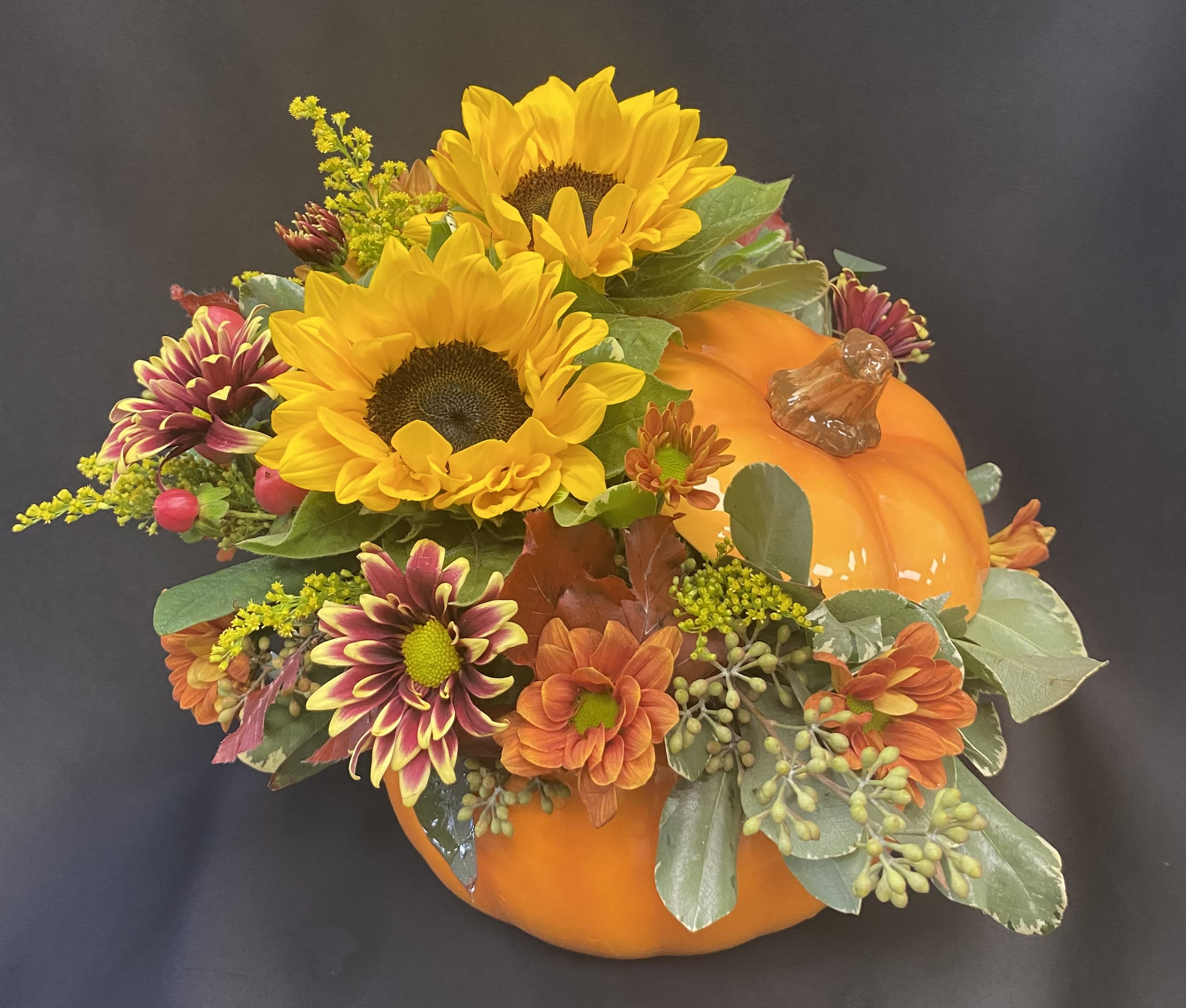 Sunflower and chrysanthemum arrangement in a pumpkin-shaped container