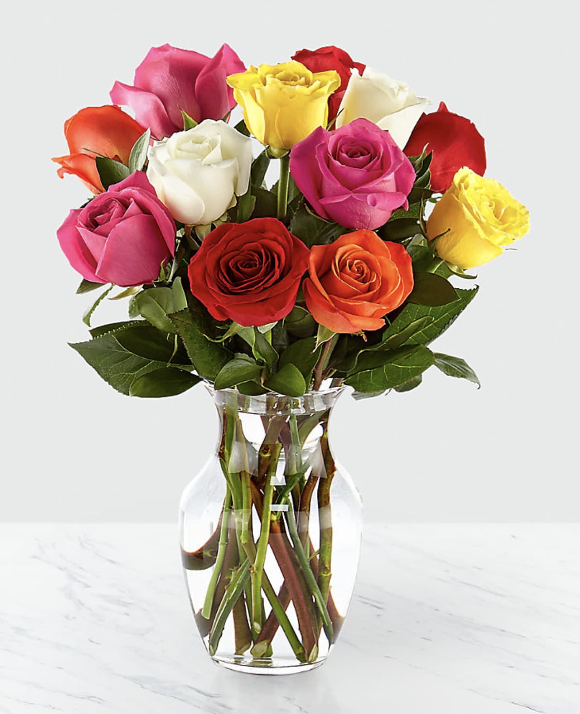 Bouquet of multicolored roses in a clear glass vase