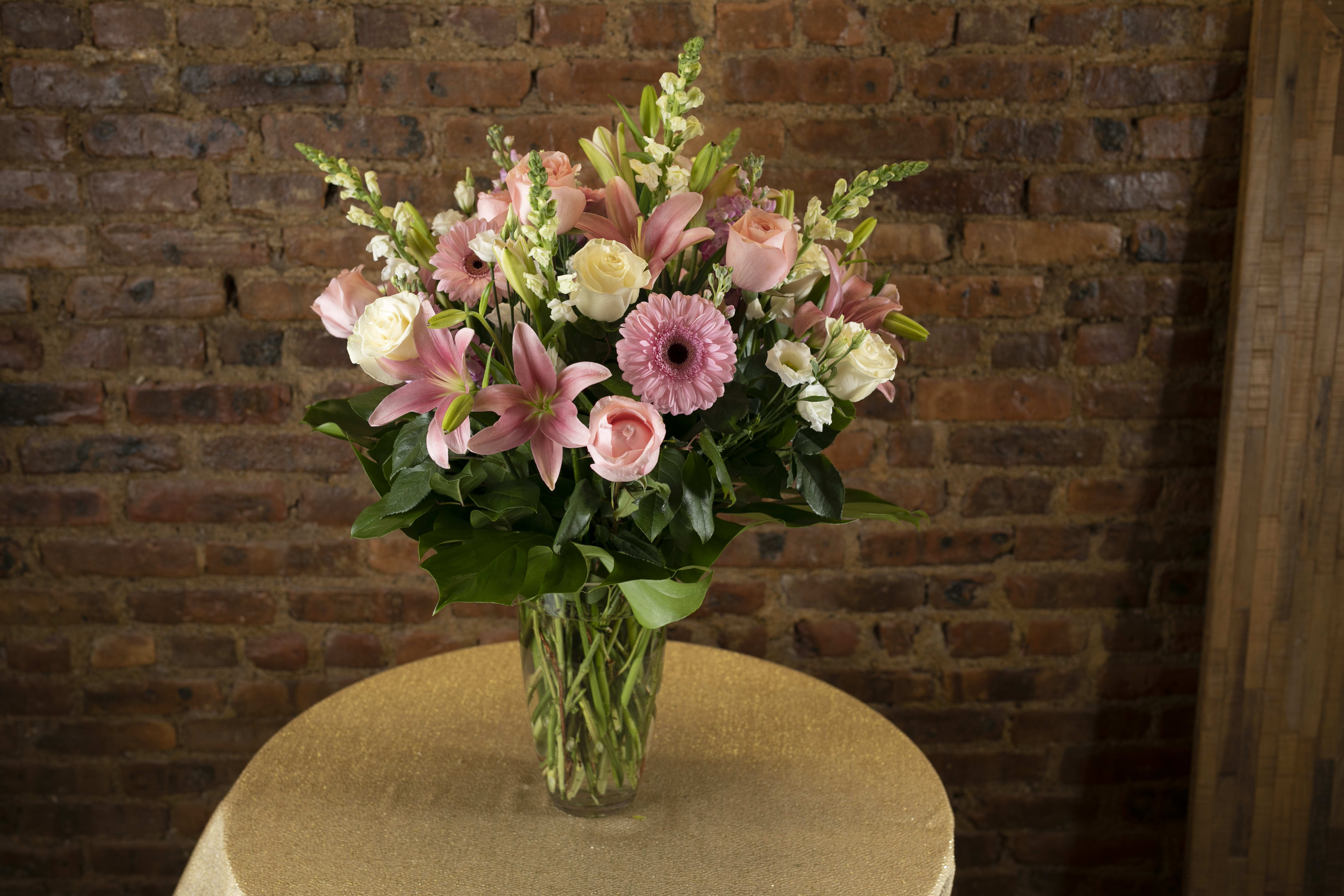 Pink and white mixed flower bouquet in a clear glass vase