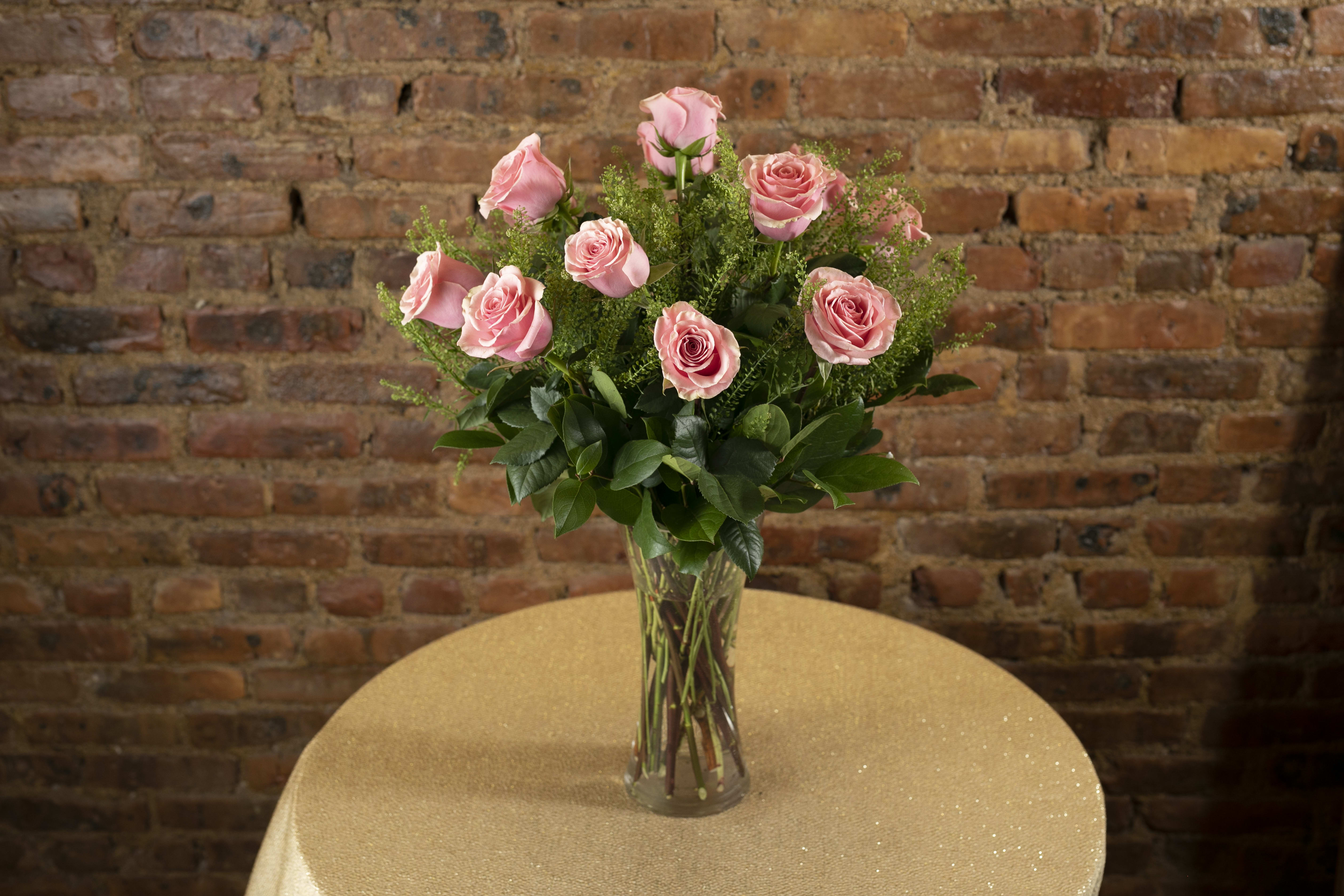 Pink roses arranged in a clear glass vase