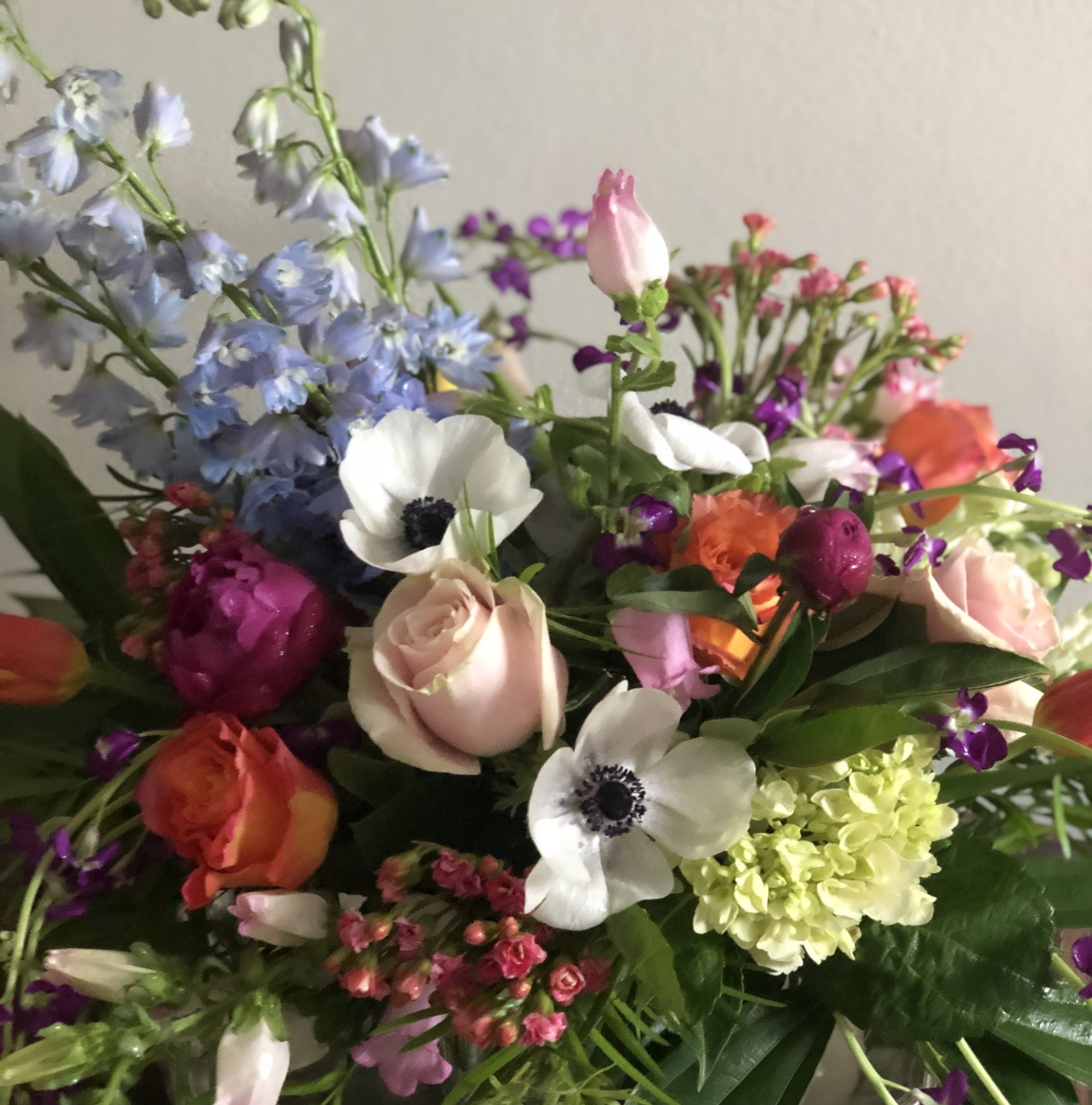 Mixed bouquet with pastel and bright flowers including roses and anemones