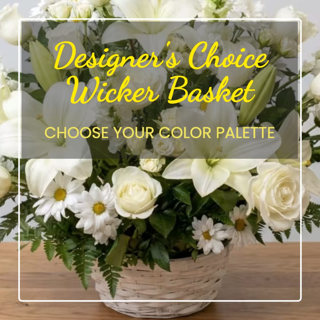 White flower arrangement in a wicker basket with daisies and roses