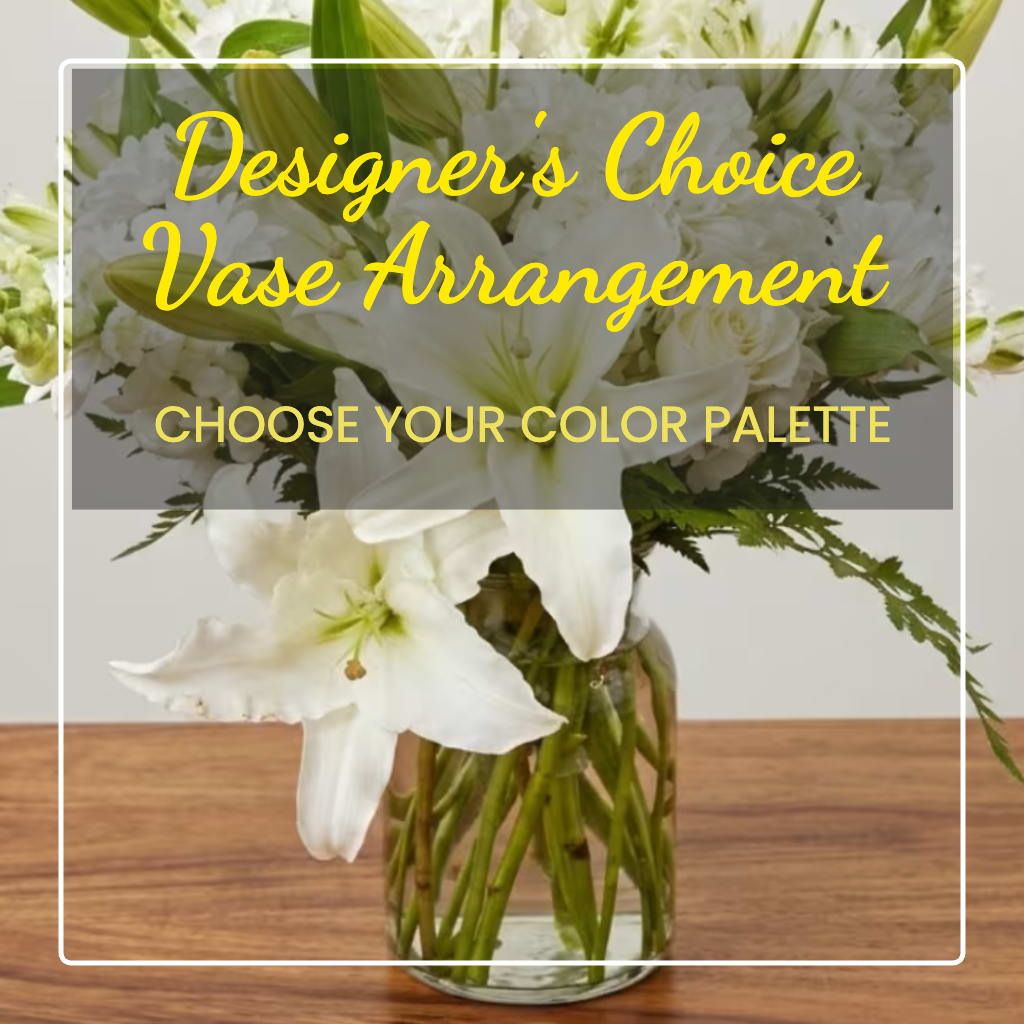 White lilies and roses arranged in a clear glass vase