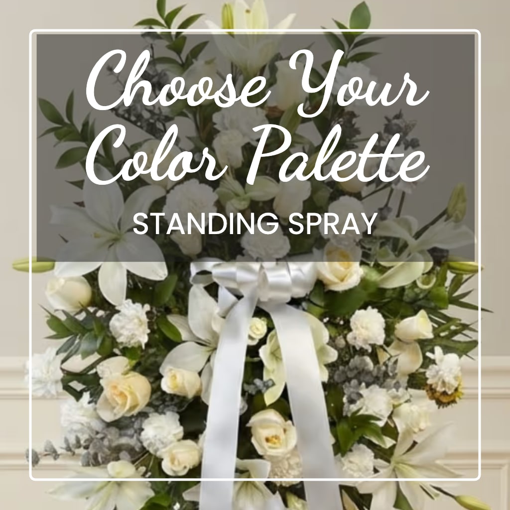 White standing spray with lilies, roses, and a satin ribbon