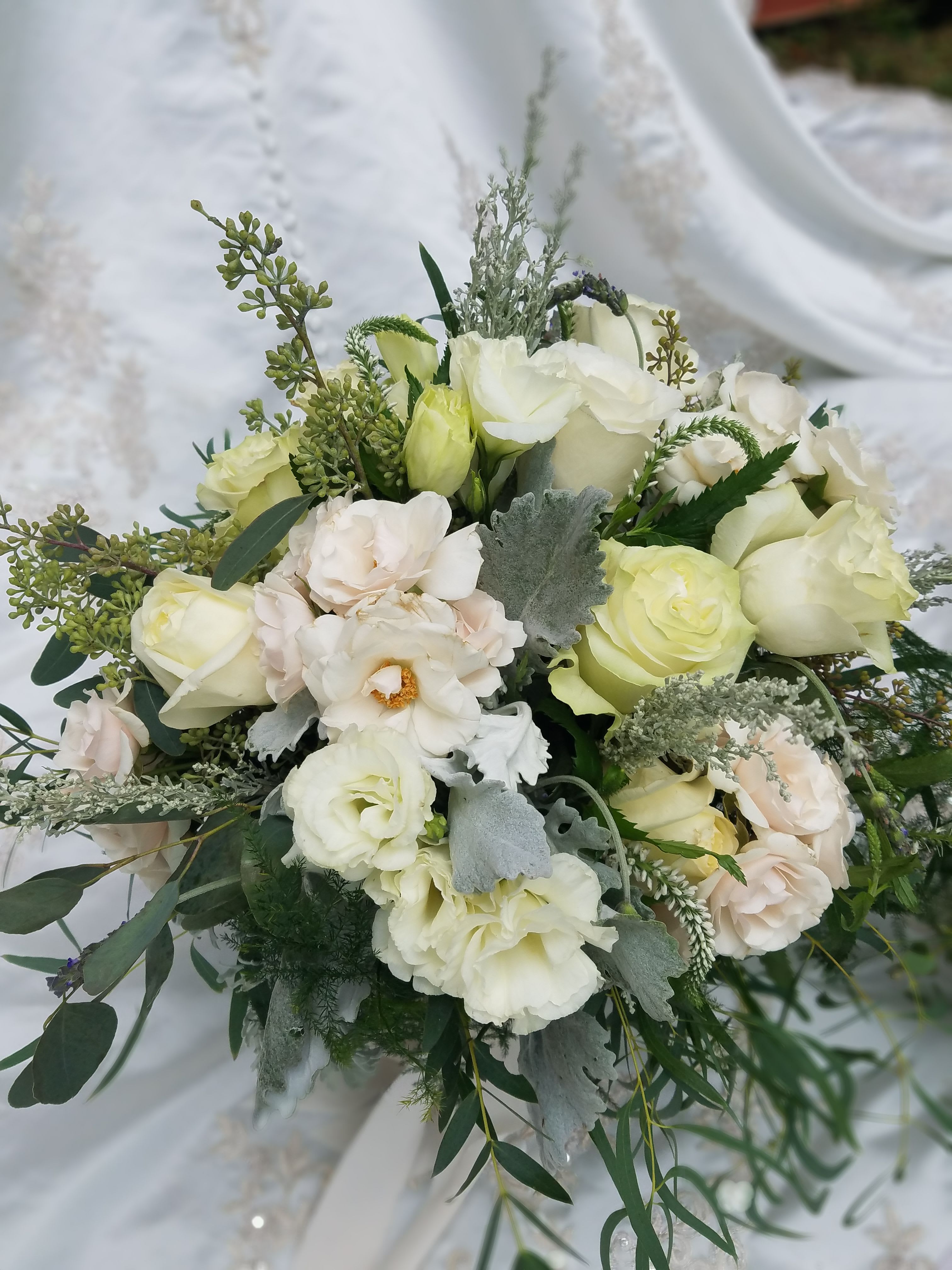 White and pale green bridal bouquet with roses and lisianthus