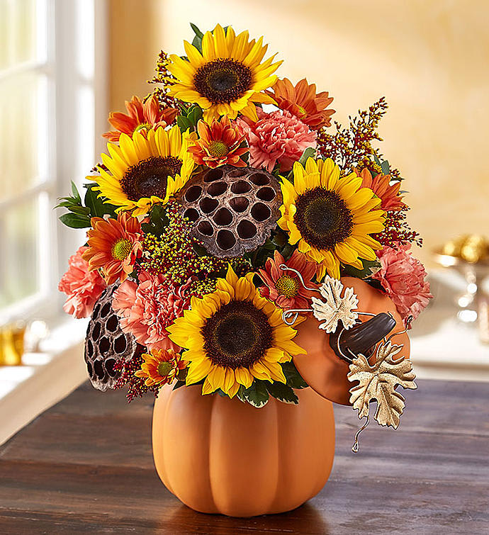 Pumpkin n' Posies  -  With its chic &amp; charming gold leaf detail, our original pumpkin arrangement is a lovely autumn gift to share. Richly-colored blooms blend with rustic, natural accents for a perfect presentation. And whether it’s used to hold candy, cookies or as part of their seasonal décor, our artisan canister will add warmth to their home year after year.