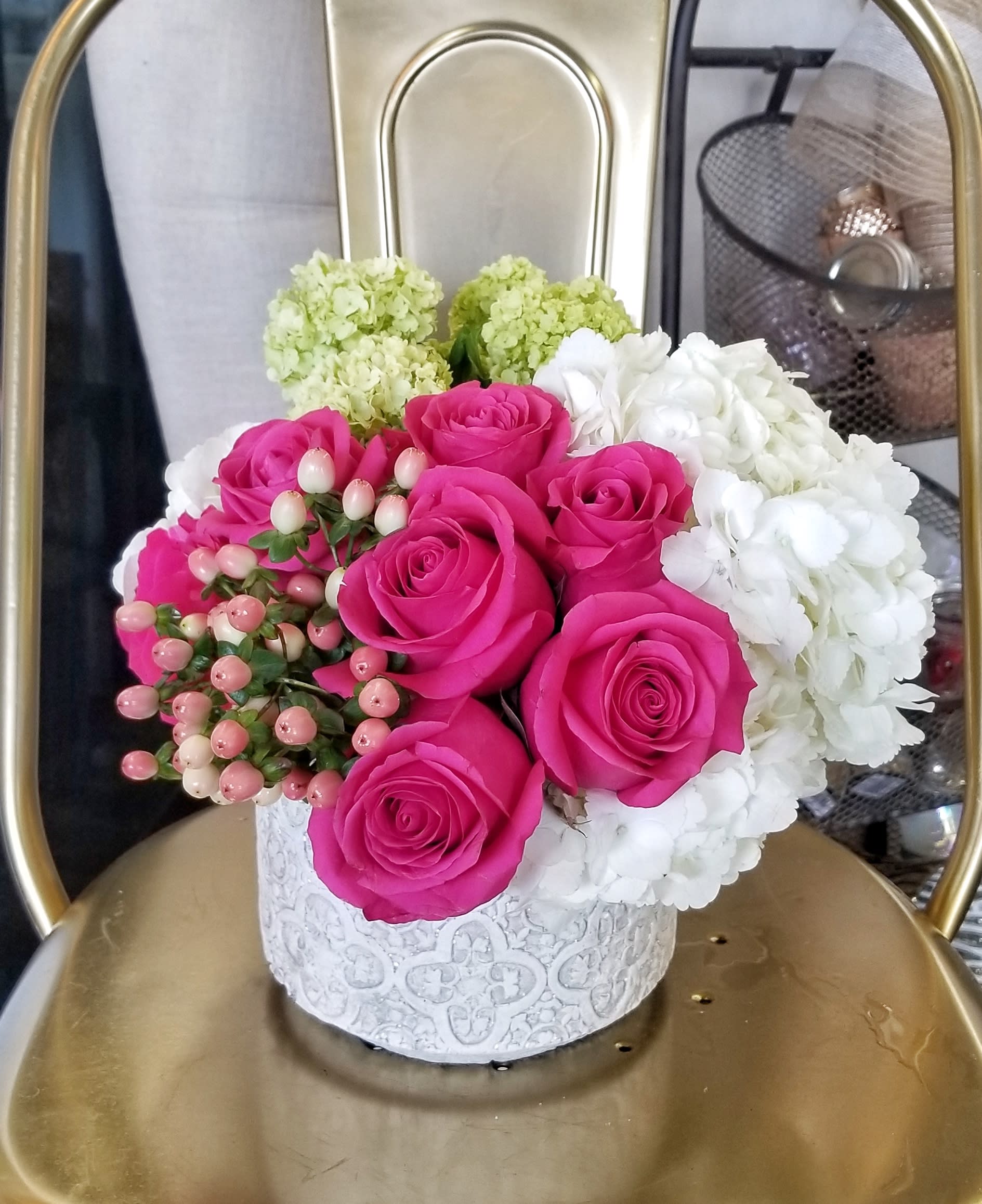 Pink roses and white hydrangeas in a white decorative box