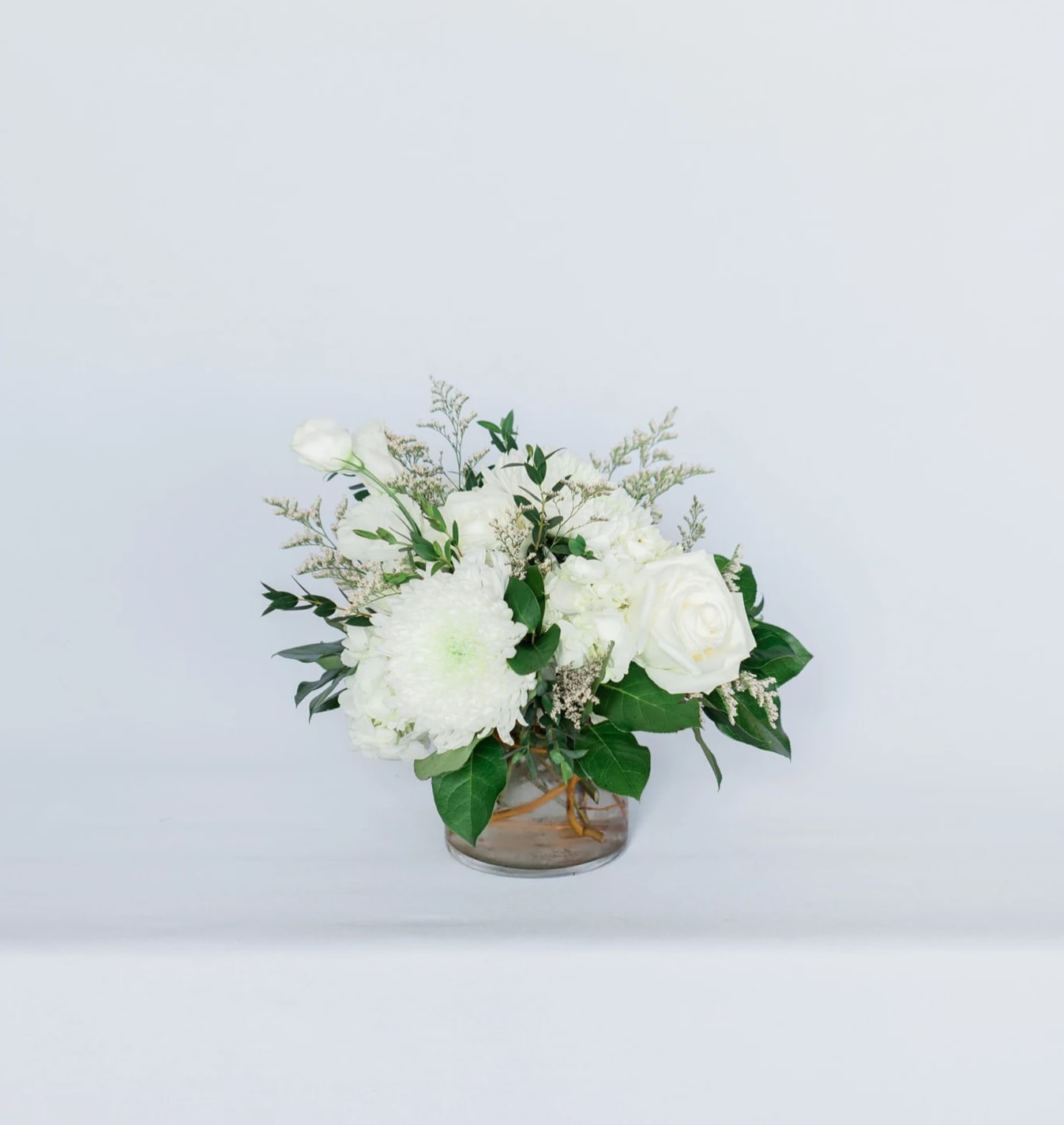 White floral arrangement in a clear glass vase
