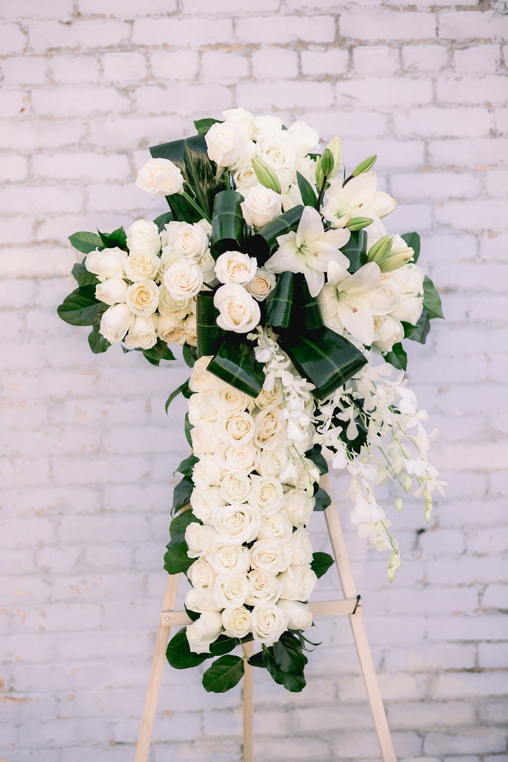 White rose and lily standing spray on an easel